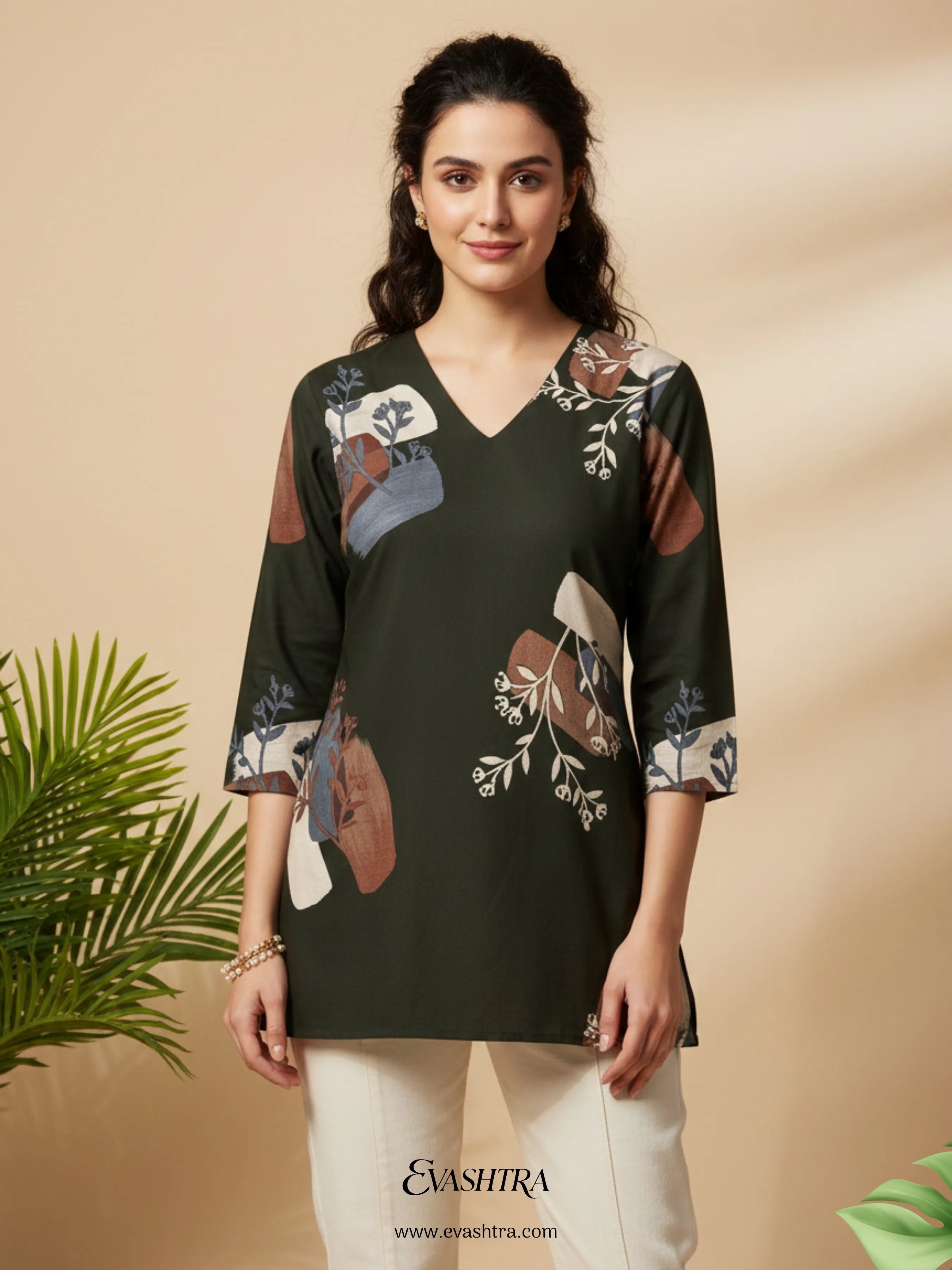 Woman wearing a dark green floral printed top with a beige background