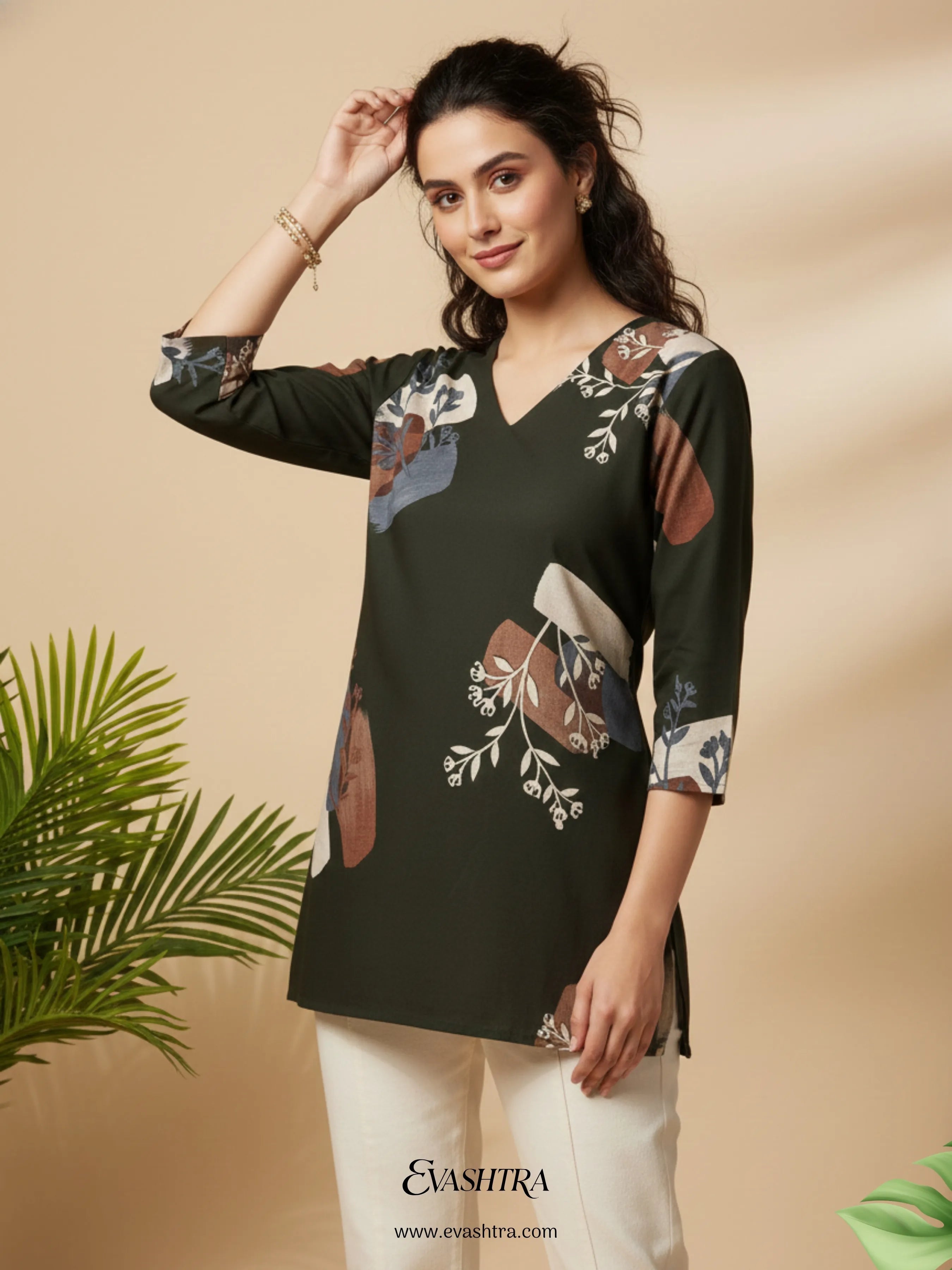 Woman wearing a black floral printed top with a beige background