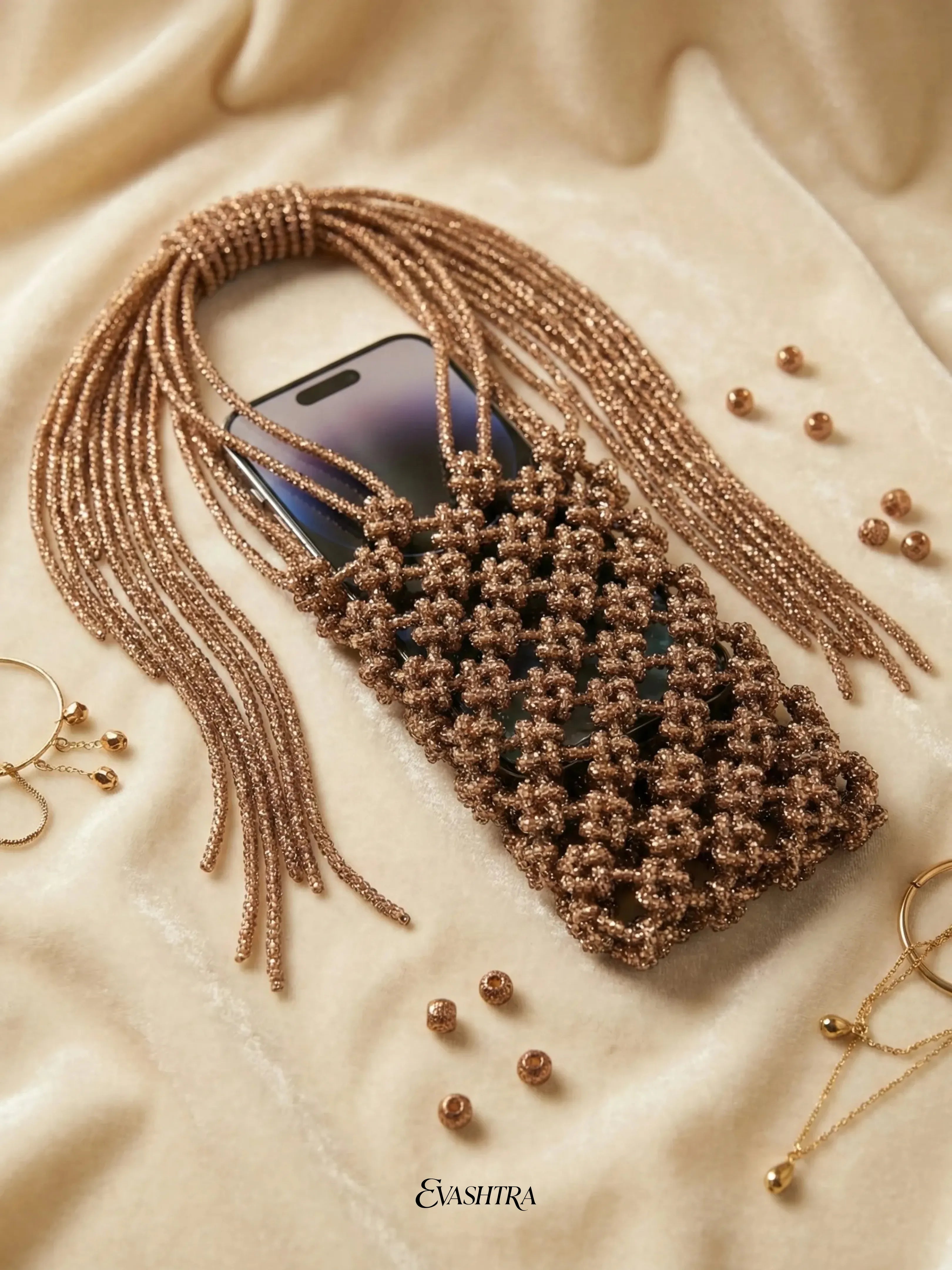 Brown beaded phone case on a beige fabric background with 'Evasitra' branding.