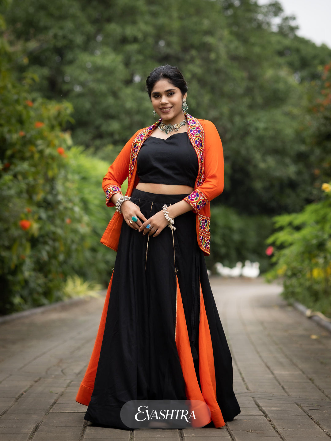 Woman wearing a black and orange traditional outfit