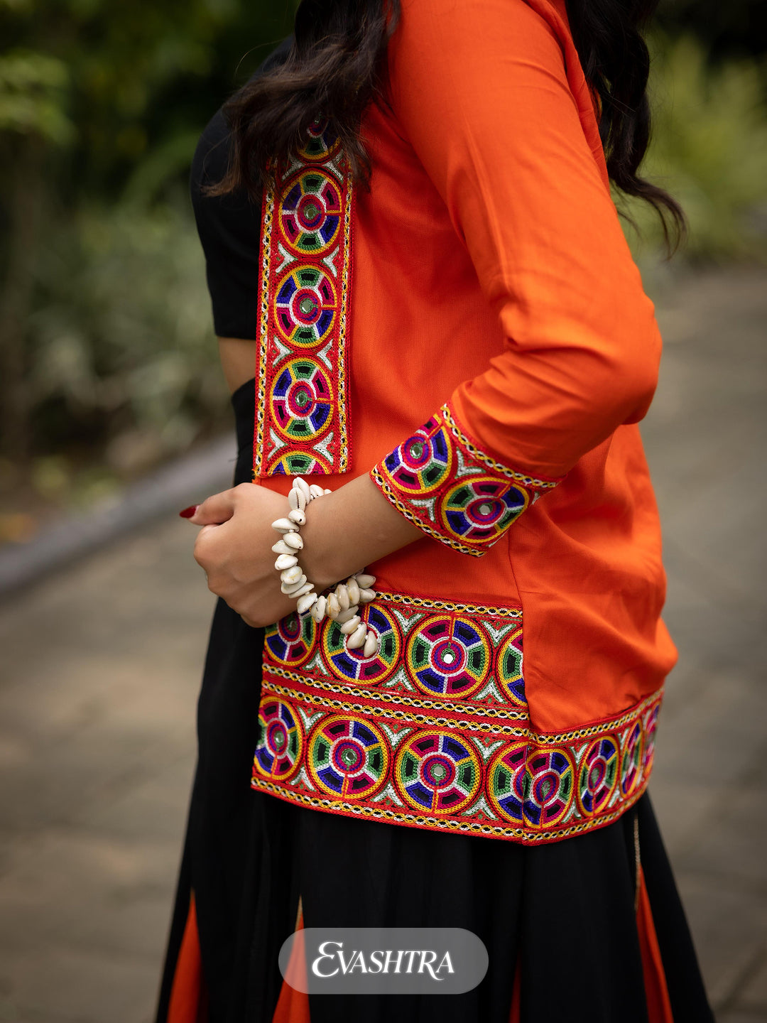 Orange traditional outfit with colorful embroidery