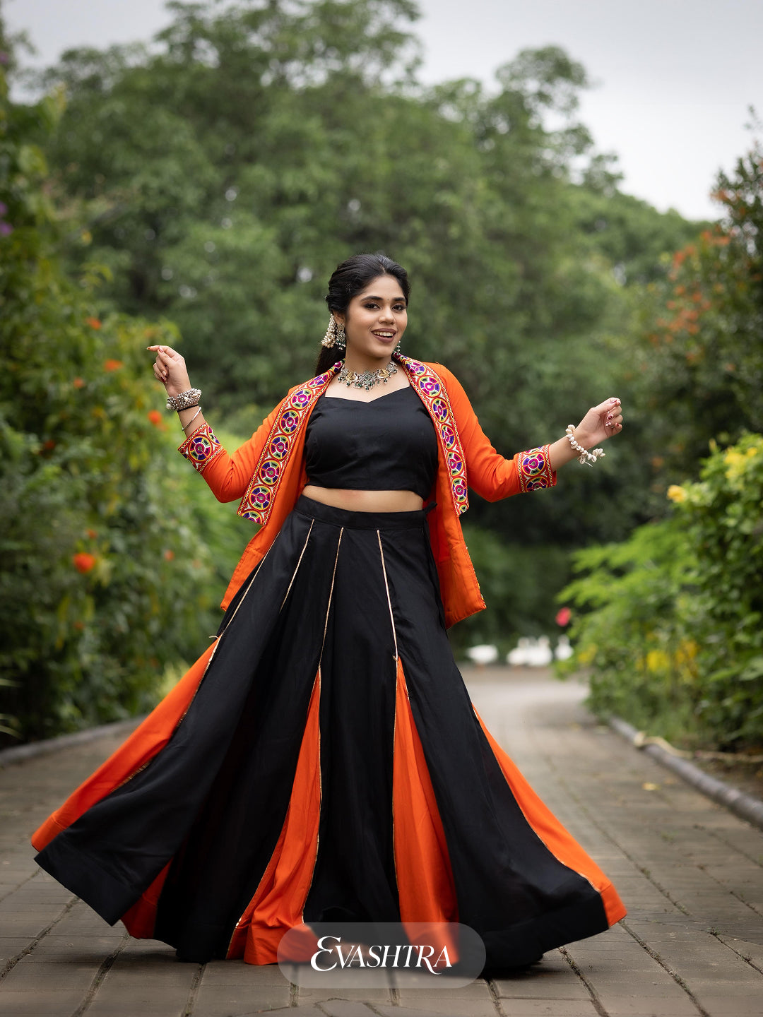 Woman in traditional black and orange outfit