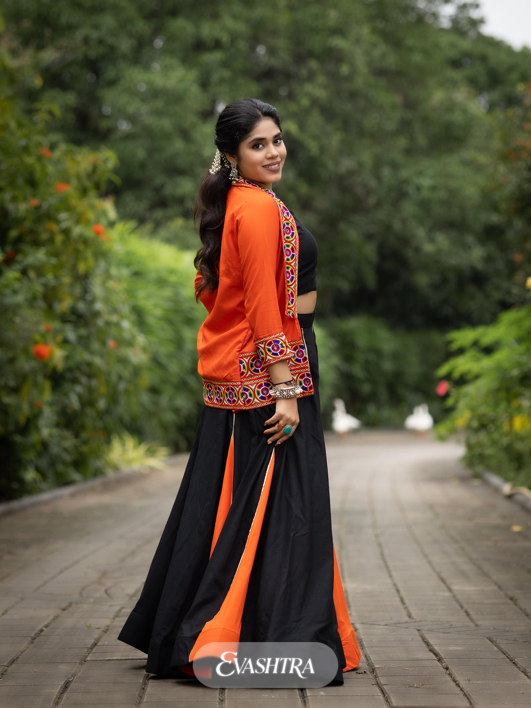 Woman in traditional black and orange outfit
