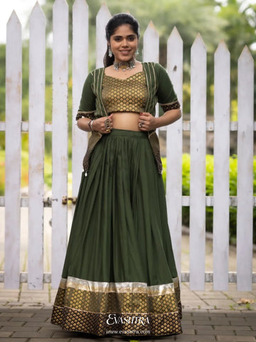 Woman wearing a green traditional outfit with a white picket fence 1