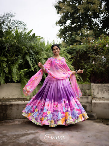 Front view of woman wearing Blossom Cascade printed lehenga in orchid pink with floral and geometric design, paired with matching dupatta.