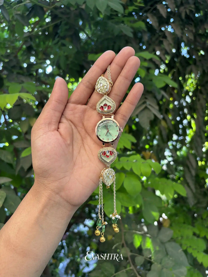 Decorative keychain held in a hand with a blurred green leafy background